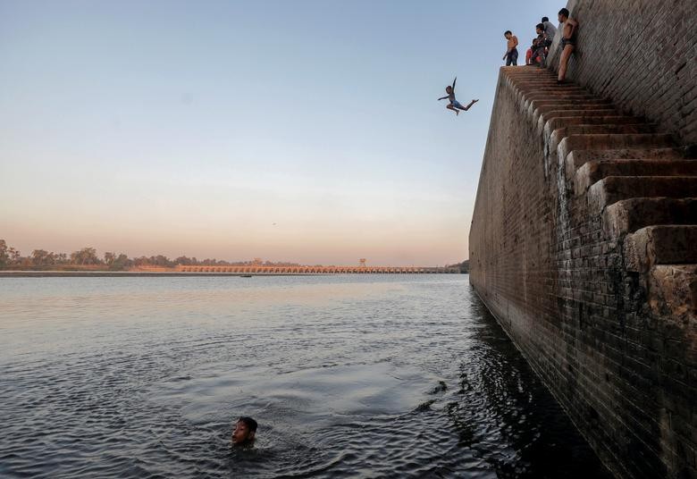 A boy jumps in the Nile River during hot weather on the outskirts of Cairo, Egypt. REUTERS/Mohamed Abd El Ghany  